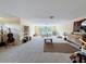 Bright, open living room with neutral tones, carpet flooring, and a large window for natural light at 22925 Collridge Dr, Land O Lakes, FL 34639