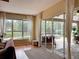 Bright living room features hardwood floors, large windows with water view, and sliding doors to the screened lanai at 22925 Collridge Dr, Land O Lakes, FL 34639