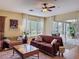 Cozy living room with hardwood floors, ceiling fan, and sliding doors to the outdoor patio at 22925 Collridge Dr, Land O Lakes, FL 34639