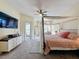 Relaxing main bedroom with a large bed, soft lighting, and direct access to the outdoor living space at 22925 Collridge Dr, Land O Lakes, FL 34639