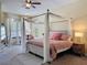 Main bedroom with a four-poster bed, large windows, and a calming color scheme at 22925 Collridge Dr, Land O Lakes, FL 34639