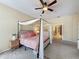 This bedroom features a cozy bed, a ceiling fan, and a neutral color scheme at 22925 Collridge Dr, Land O Lakes, FL 34639