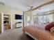 Large main bedroom with a four-poster bed, television, and lots of natural light at 22925 Collridge Dr, Land O Lakes, FL 34639