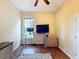 Bright office space featuring hardwood floors, a ceiling fan, and a large window at 22925 Collridge Dr, Land O Lakes, FL 34639