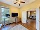 Bright office space featuring hardwood floors, a ceiling fan, and a large window at 22925 Collridge Dr, Land O Lakes, FL 34639