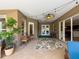 Inviting covered patio featuring stylish decor, a ceiling fan, and sliding glass doors for seamless indoor-outdoor living at 22925 Collridge Dr, Land O Lakes, FL 34639