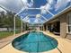 Sparkling pool and spa surrounded by screened enclosure and lush landscaping offer a private outdoor retreat at 22925 Collridge Dr, Land O Lakes, FL 34639