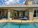 Relax by the pool on the covered patio, with views of the sparkling water and lush landscaping at 22925 Collridge Dr, Land O Lakes, FL 34639