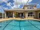 Enjoy the home's outdoor living space, with a covered patio and sparkling swimming pool at 22925 Collridge Dr, Land O Lakes, FL 34639