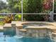 Beautiful in-ground swimming pool and hot tub surrounded by lush tropical landscaping at 22925 Collridge Dr, Land O Lakes, FL 34639