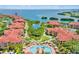 Aerial view of a community featuring tile roofs, lush greenery, and a sparkling swimming pool at 2739 Via Capri # 1039, Clearwater, FL 33764