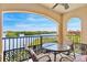 Relaxing balcony seating with serene water view, perfect for outdoor enjoyment with ornate black iron railing at 2739 Via Capri # 1039, Clearwater, FL 33764