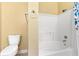Bright bathroom featuring a pristine white tub and shower with a blue floral shower curtain at 2739 Via Capri # 1039, Clearwater, FL 33764