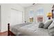 Inviting bedroom featuring two windows, wood floors, and closet at 2739 Via Capri # 1039, Clearwater, FL 33764