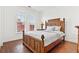 Well-lit bedroom features wood floors, a carved headboard, and lots of natural light at 2739 Via Capri # 1039, Clearwater, FL 33764