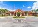 Beautiful Grand Palm clubhouse with flags and mature landscaping at 2739 Via Capri # 1039, Clearwater, FL 33764