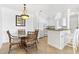 Dining area features a glass table, rattan chairs, and stylish lighting at 2739 Via Capri # 1039, Clearwater, FL 33764