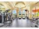 Bright gym with modern equipment, arched windows, and mirrored wall at 2739 Via Capri # 1039, Clearwater, FL 33764