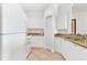 Galley kitchen with white cabinetry, granite countertops, and stainless appliances at 2739 Via Capri # 1039, Clearwater, FL 33764