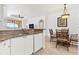 Well-lit kitchen features granite counters, stainless steel sink, and an adjacent dining area at 2739 Via Capri # 1039, Clearwater, FL 33764