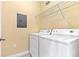 Convenient laundry area featuring a washer and dryer with overhead shelving at 2739 Via Capri # 1039, Clearwater, FL 33764