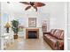 Charming living room featuring a cozy fireplace, desk, and a comfortable leather sofa with natural light at 2739 Via Capri # 1039, Clearwater, FL 33764