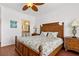 Main bedroom has wood floors, a decorative headboard, and ensuite access at 2739 Via Capri # 1039, Clearwater, FL 33764