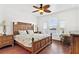 Spacious main bedroom featuring wood floors, a ceiling fan, and water views at 2739 Via Capri # 1039, Clearwater, FL 33764