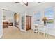Bright office space with a water view, desk, and seamless flow into the connected living room area at 2739 Via Capri # 1039, Clearwater, FL 33764