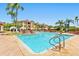 Beautiful swimming pool with palm trees and lounge chairs; perfect for relaxation, with nearby buildings at 2739 Via Capri # 1039, Clearwater, FL 33764