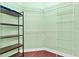 Walk-in closet offering ample storage with wire shelving and dark wood shelving units at 2739 Via Capri # 1039, Clearwater, FL 33764