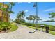 Paver walkway along waterfront with palm trees, and a grill at 2739 Via Capri # 1039, Clearwater, FL 33764