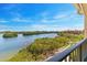 Beautiful water view from the balcony of a building with lush green trees at 2739 Via Capri # 1039, Clearwater, FL 33764