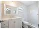 A clean and bright bathroom with a modern vanity, large mirror, and beautifully tiled shower and flooring at 314 Circle Dr, Palm Harbor, FL 34683