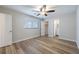 A bright bedroom featuring modern wood-look floors, a walk-in closet, and access to an en suite bathroom at 314 Circle Dr, Palm Harbor, FL 34683