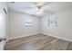A bedroom featuring wood-look flooring, modern paint, a ceiling fan, and great natural light at 314 Circle Dr, Palm Harbor, FL 34683