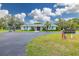 Exterior view of community center with lush landscaping, recreational amenities, and waterfront access at 314 Circle Dr, Palm Harbor, FL 34683