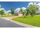 Well-maintained single-story brick home featuring a lush green lawn, mature trees, and a paved driveway at 314 Circle Dr, Palm Harbor, FL 34683