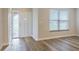 Bright foyer featuring a white front door, a window with blinds, and light-colored hard surface floors at 314 Circle Dr, Palm Harbor, FL 34683