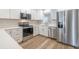 Bright kitchen features stainless steel appliances, quartz countertops, and hardwood floors at 314 Circle Dr, Palm Harbor, FL 34683