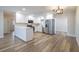 Bright kitchen features white cabinets, stainless steel appliances, quartz countertops, and hardwood floors at 314 Circle Dr, Palm Harbor, FL 34683