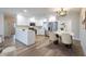 Bright kitchen features white cabinets, stainless steel appliances, quartz countertops, and a dining area at 314 Circle Dr, Palm Harbor, FL 34683