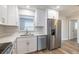 Bright kitchen features stainless steel appliances, quartz countertops, hardwood floors, and ample sunlight at 314 Circle Dr, Palm Harbor, FL 34683