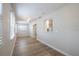 Open living room with neutral decor, bright windows, ceiling fan, and hardwood floors at 314 Circle Dr, Palm Harbor, FL 34683
