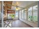 A sunroom offers a ceiling fan, lots of natural light, and access to the fenced-in backyard at 314 Circle Dr, Palm Harbor, FL 34683