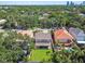 This aerial view shows the home's backyard and the neighboring houses and pool at 3304 W Harbor View Ave, Tampa, FL 33611
