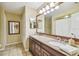 Well-lit bathroom has a granite vanity with dual sinks and tile floors at 3304 W Harbor View Ave, Tampa, FL 33611