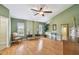 Spacious bedroom featuring laminate floors, bright windows, and elegant furnishings at 3304 W Harbor View Ave, Tampa, FL 33611