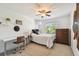 Cozy bedroom featuring a ceiling fan, a comfortable bed, and a functional desk area at 3304 W Harbor View Ave, Tampa, FL 33611