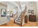 Inviting foyer with hardwood floors, a staircase, and views into the dining and living spaces at 3304 W Harbor View Ave, Tampa, FL 33611